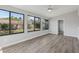 Bright living room with lots of large windows and wood-look floors at 525 Legume Dr, Port Orange, FL 32127