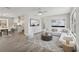Bright living room with gray-toned walls, white furniture, and an open floor plan at 525 Legume Dr, Port Orange, FL 32127