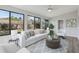 Inviting living room filled with natural light from large windows overlooking the backyard at 525 Legume Dr, Port Orange, FL 32127