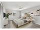 Comfortable bedroom with neutral colors, ceiling fan, and natural light from two windows at 525 Legume Dr, Port Orange, FL 32127