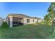 Well-maintained backyard with lush green lawn and screened patio at 543 Pine Tree Bridge Trl, St Cloud, FL 34772
