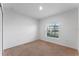 This bedroom features neutral carpeting and a sunlit window at 543 Pine Tree Bridge Trl, St Cloud, FL 34772