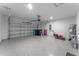 Garage with speckled floor, lawn mower and garage door at 543 Pine Tree Bridge Trl, St Cloud, FL 34772