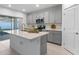 Open kitchen with an island, stainless steel appliances, and gray cabinets at 543 Pine Tree Bridge Trl, St Cloud, FL 34772