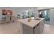 Open-concept kitchen with an island, stainless steel appliances, and a view into the dining and living areas at 543 Pine Tree Bridge Trl, St Cloud, FL 34772