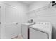 Laundry room featuring washer, dryer, and wire shelving at 543 Pine Tree Bridge Trl, St Cloud, FL 34772