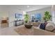 Cozy living room with natural light, neutral decor, and an adjacent view into the main bedroom at 543 Pine Tree Bridge Trl, St Cloud, FL 34772