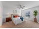 Bright main bedroom with a ceiling fan, neutral carpet, a large window, and white walls at 543 Pine Tree Bridge Trl, St Cloud, FL 34772