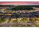 Night view of a well-lit residential street showcasing neatly landscaped lawns and modern homes with illuminated driveways at 543 Pine Tree Bridge Trl, St Cloud, FL 34772