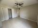Bedroom featuring tile flooring, ceiling fan, and a closet at 601 Casa Park Court B Ct, Winter Springs, FL 32708