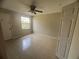 Clean, bright bedroom featuring tile floors, a ceiling fan, and plenty of natural light from the window at 601 Casa Park Court B Ct, Winter Springs, FL 32708