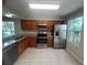 Well-lit kitchen featuring stainless steel appliances, granite countertops, and ample cabinet space at 601 Casa Park Court B Ct, Winter Springs, FL 32708