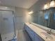 Bathroom with a double sink vanity, tile floors, shower with glass door and subway tile surround at 620 Pothos St, Apopka, FL 32703
