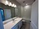 Full bathroom featuring tile floors, subway tile surround on the tub, white vanity and lighting at 620 Pothos St, Apopka, FL 32703