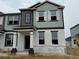 New construction townhouse with light blue and gray color scheme, white trim, and covered front entry at 620 Pothos St, Apopka, FL 32703