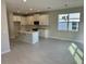 Spacious kitchen with a center island, stainless steel appliances, tile floors, and open dining area at 620 Pothos St, Apopka, FL 32703