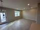 Bright living room with modern floors, recessed lighting, and a glass door to the outside at 620 Pothos St, Apopka, FL 32703