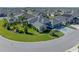Beautiful aerial view of a home featuring a well-manicured lawn and mature trees at 6328 Merhottein Loop, The Villages, FL 32163