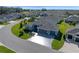 Overhead view of a gray home showcasing pristine landscaping and a three car garage at 6328 Merhottein Loop, The Villages, FL 32163