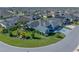 Expansive aerial view highlighting a home with solar panels and verdant landscaping at 6328 Merhottein Loop, The Villages, FL 32163