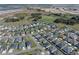 Expansive aerial view of the community, showcasing lush green golf courses, serene ponds, and beautifully landscaped homes at 6328 Merhottein Loop, The Villages, FL 32163