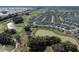 Expansive aerial view of the community, with lush green golf courses, serene ponds, and beautifully landscaped homes at 6328 Merhottein Loop, The Villages, FL 32163