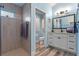 Updated bathroom featuring dual vanity, shower, toilet room, and modern fixtures with white cabinets at 6328 Merhottein Loop, The Villages, FL 32163