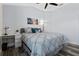 Cozy bedroom with a ceiling fan, wood-look flooring, and a comfortable bed with decorative pillows at 6328 Merhottein Loop, The Villages, FL 32163