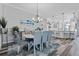 Bright dining area with a view to the kitchen featuring sleek floors and modern decor at 6328 Merhottein Loop, The Villages, FL 32163