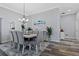 Elegant dining room with designer lighting, neutral wall tones, and decorative molding and trim at 6328 Merhottein Loop, The Villages, FL 32163