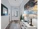 Inviting entryway showcasing beautiful floors, stylish furniture, artwork, and an elegant front door at 6328 Merhottein Loop, The Villages, FL 32163