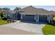 Well maintained single story home featuring a three car garage and decorative concrete driveway at 6328 Merhottein Loop, The Villages, FL 32163