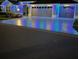 Nighttime exterior view of a home illuminated with holiday lights, enhancing its curb appeal, and a paved driveway at 6328 Merhottein Loop, The Villages, FL 32163