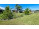Charming single-story home featuring lush landscaping and healthy green lawn at 6328 Merhottein Loop, The Villages, FL 32163