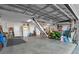 Spacious garage features ample storage, work space, and convenient access via interior door and ladder to attic at 6328 Merhottein Loop, The Villages, FL 32163
