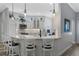 Kitchen features stainless appliances, updated backsplash, and breakfast bar with barstool seating and views to a small desk at 6328 Merhottein Loop, The Villages, FL 32163