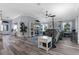 Open-concept living area featuring a large sectional sofa and wood-look tile flooring at 6328 Merhottein Loop, The Villages, FL 32163
