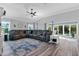 Living room features a sectional sofa and sliding doors leading to the outdoor living space at 6328 Merhottein Loop, The Villages, FL 32163