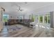 Bright living room featuring a plush sectional sofa and sliding glass doors to the outdoor space at 6328 Merhottein Loop, The Villages, FL 32163
