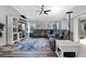 Comfortable living room featuring a large sectional sofa and a modern entertainment center at 6328 Merhottein Loop, The Villages, FL 32163