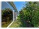 View of the side of the house showing access to the backyard and its meticulous landscaping at 6328 Merhottein Loop, The Villages, FL 32163