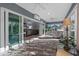 Bright sunroom has a view to other living areas, tiled floor, and sliding glass door access to the outdoors at 6328 Merhottein Loop, The Villages, FL 32163