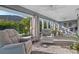 Bright sunroom with a ceiling fan, and large windows offering picturesque views of the greenery at 6328 Merhottein Loop, The Villages, FL 32163