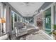 Inviting sunroom features slate floors, ceiling fans, and wall of sliding glass doors for serene relaxation and natural light at 6328 Merhottein Loop, The Villages, FL 32163