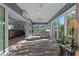 Bright sunroom has tiled floor, access to other living areas, and a wall of sliding glass doors to the outdoors at 6328 Merhottein Loop, The Villages, FL 32163