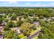 Aerial view featuring the residential area's mature landscaping and nearby lake view at 687 Saranac Dr, Winter Springs, FL 32708