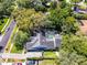 Aerial view showing the house with a screened pool and a driveway with multiple cars at 687 Saranac Dr, Winter Springs, FL 32708