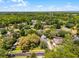 Aerial view showcasing the neighborhood's residential streets and mature tree coverage at 687 Saranac Dr, Winter Springs, FL 32708
