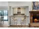 Cozy bar area with counter seating and a fireplace, ideal for relaxation and entertaining at 687 Saranac Dr, Winter Springs, FL 32708