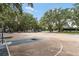 Community basketball court surrounded by mature trees providing ample shade for players at 687 Saranac Dr, Winter Springs, FL 32708